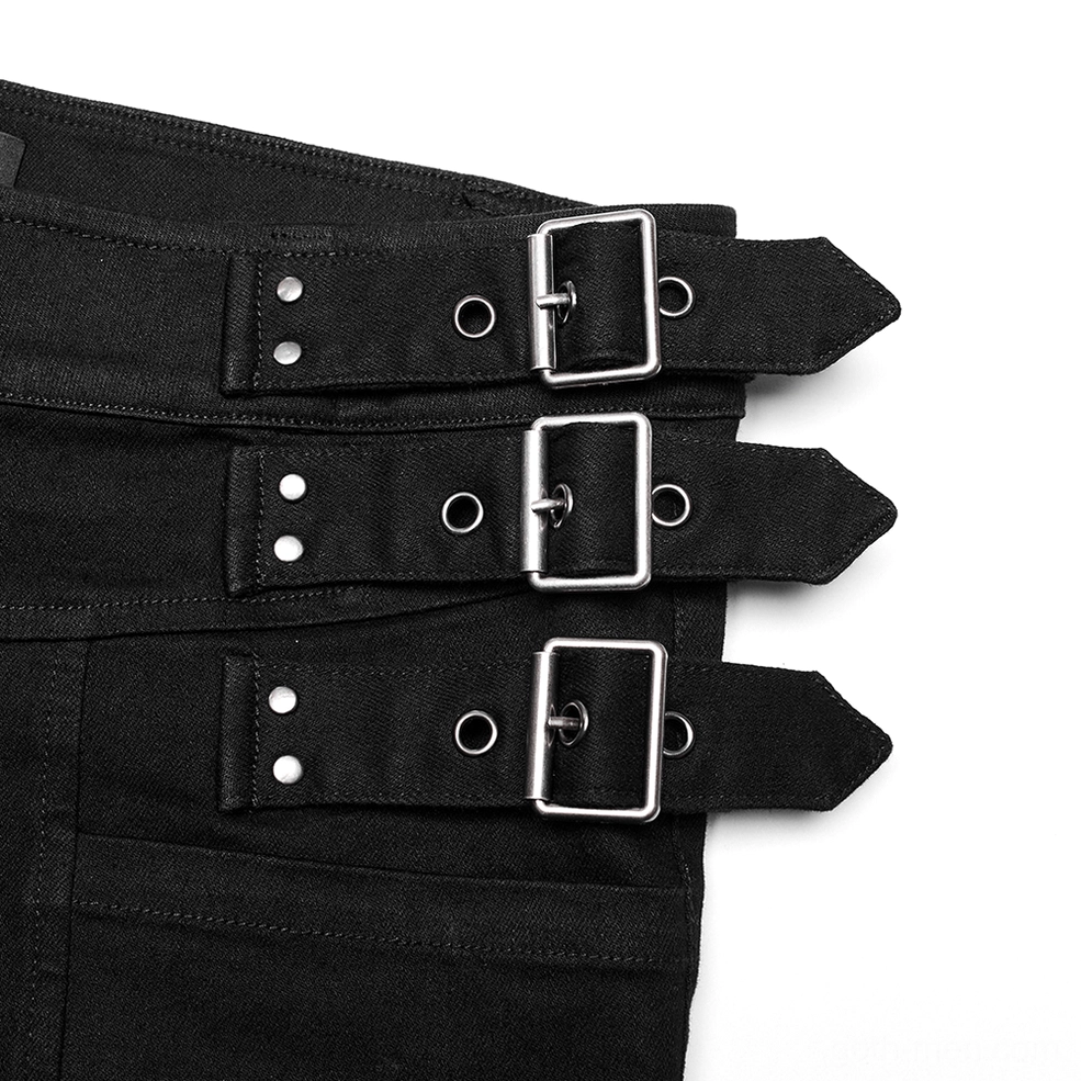Close-up of silver metal studded buckles and rivet-fastened waist straps on gothic denim pants