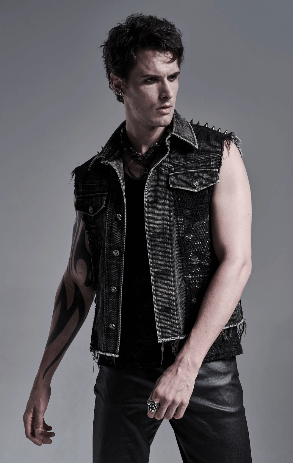 Black gothic denim vest on model - three-quarter side angle showing fitted silhouette and distressed texture