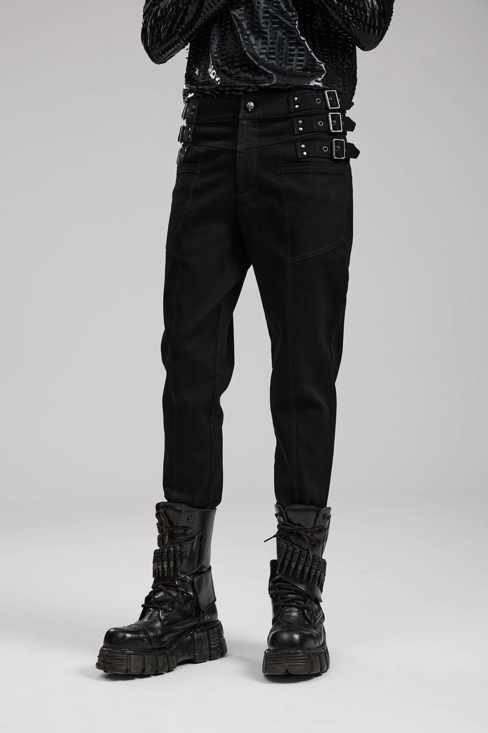 Waist area close-up of black gothic denim pants showing studded loops and hardware arrangement