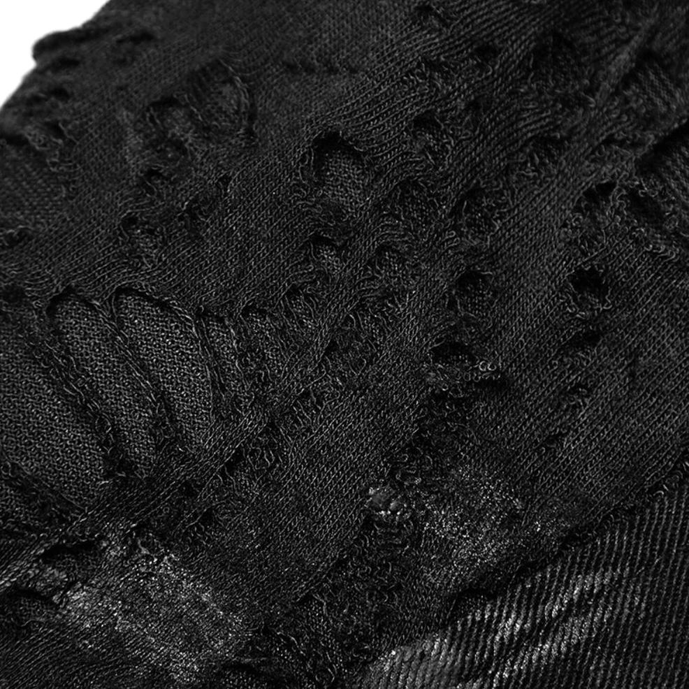 Macro close-up of frayed and distressed black denim fabric texture showing intentional wear patterns