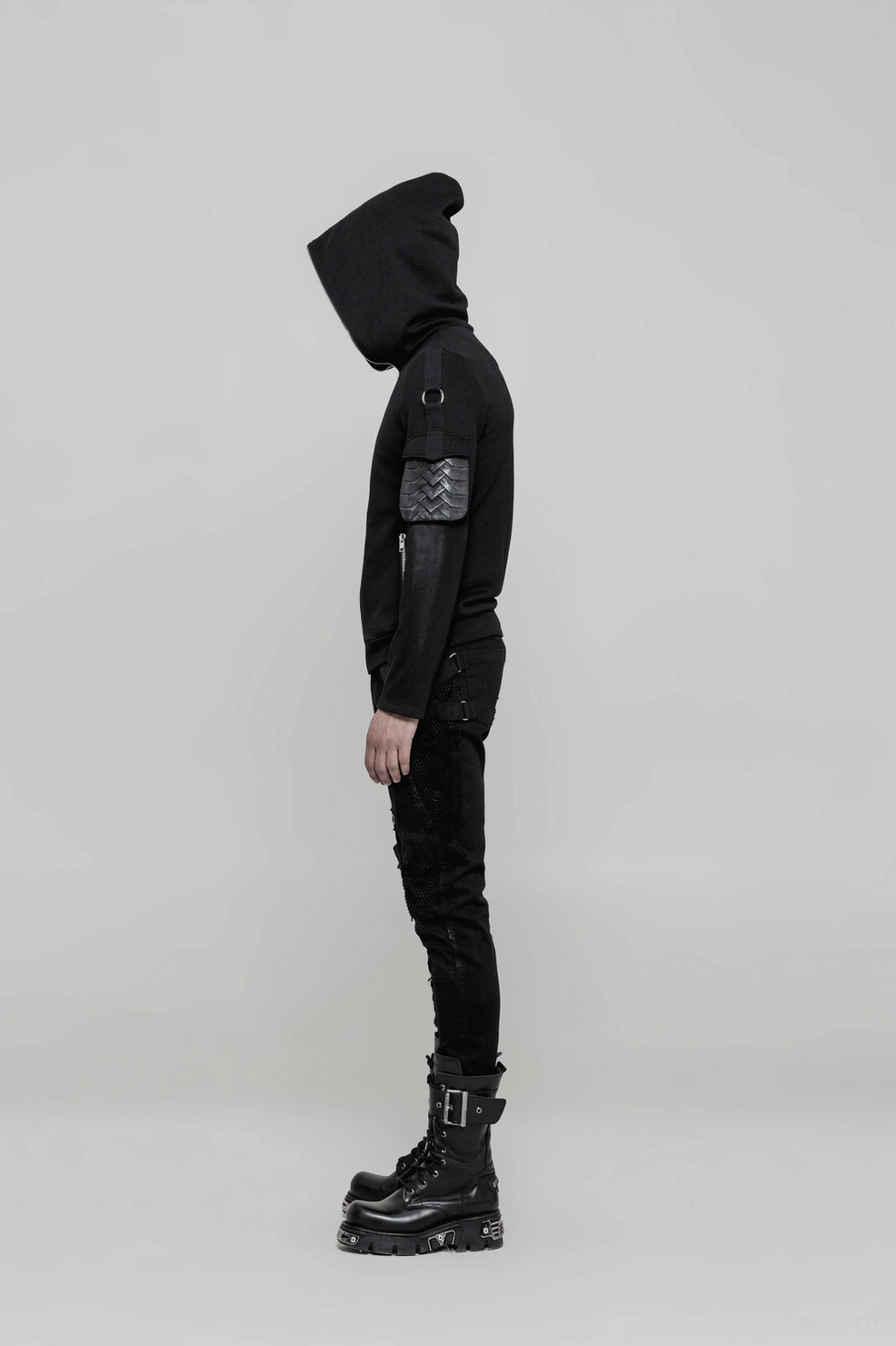 Inseam and hem detail of black gothic jeans showing stitching, metal eyelets and fitted hem width