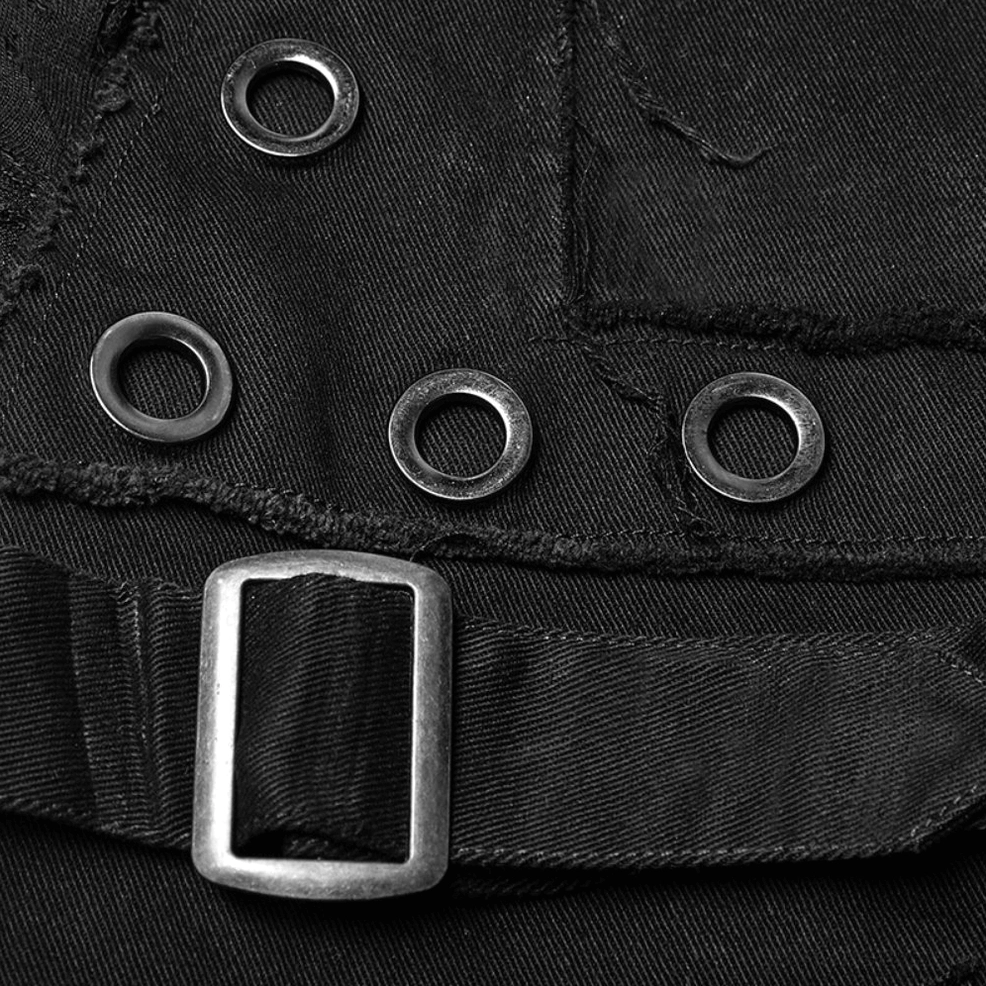Hardware close-up showing round metal eyelets, rectangular buckle and webbing strap on gothic jeans