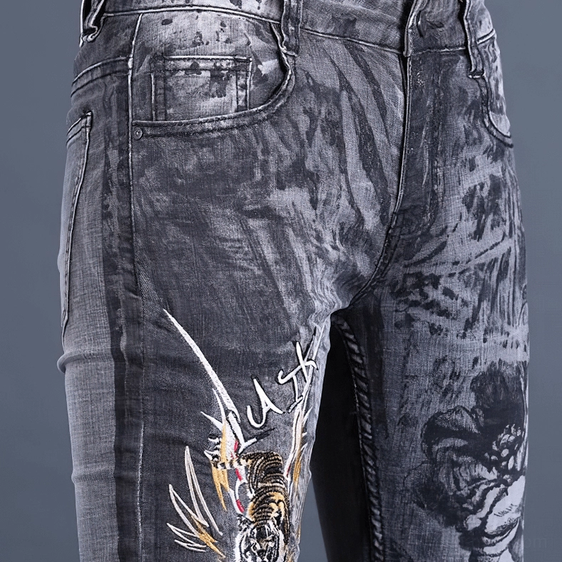 Men's gothic dragon embroidered skinny jeans full-length view with intricate embroidery and washed grey denim finish