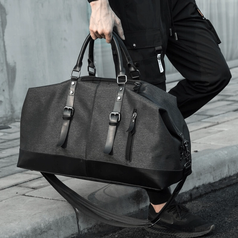 Gothic men's duffel bag styled with alternative fashion accessories and dark aesthetic lifestyle elements