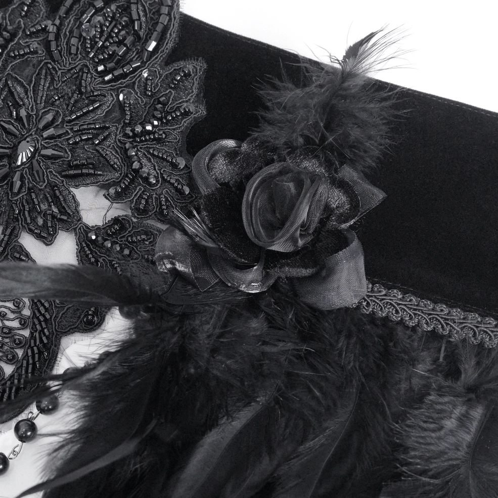 Macro closeup of gothic feather collar showing black velvet fabric, lace applique and fabric rose ornaments