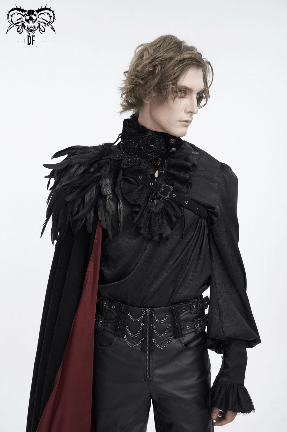 Side profile of asymmetric black feathered gothic cape showing dramatic drape and feather placement on neck and shoulder