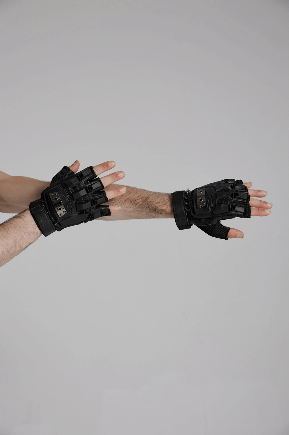 Open palms view of fingerless gothic tactical gloves, displaying leather palm and hard armor shell design