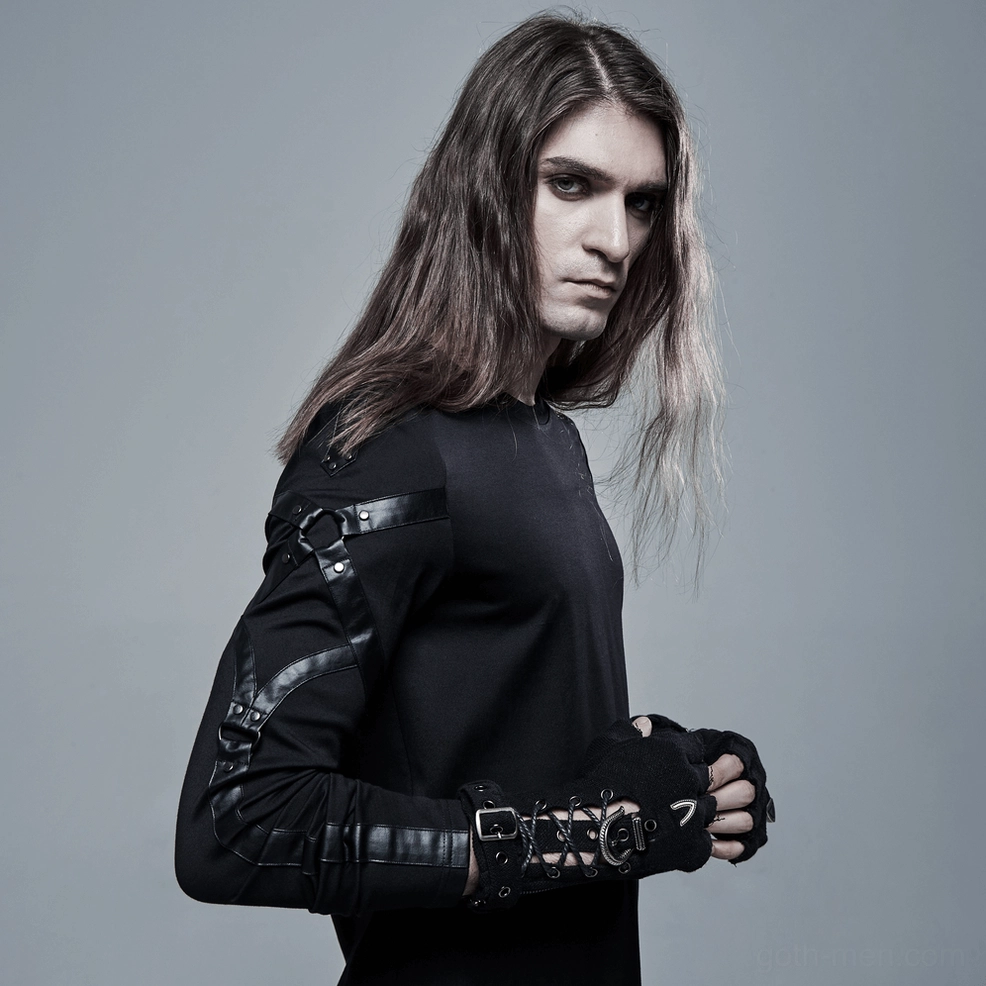 Male model wearing black gothic fingerless gloves with full all-black outfit and leather accents, side profile
