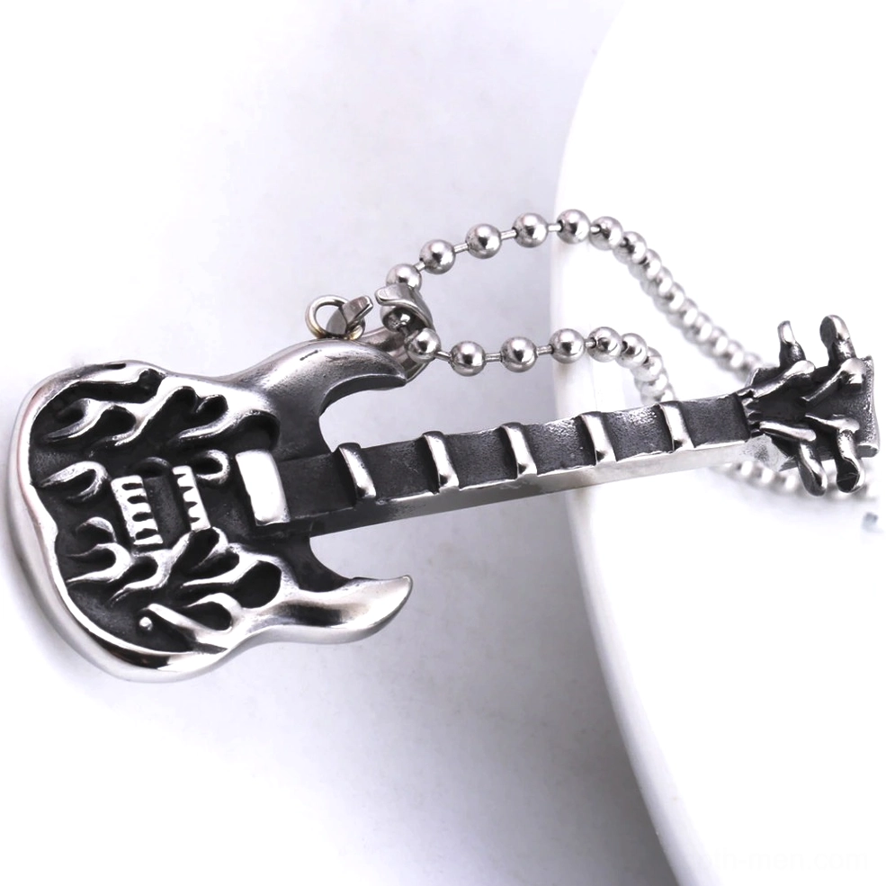 gothic guitar pendant lying flat tableware overhead view engraved flame design