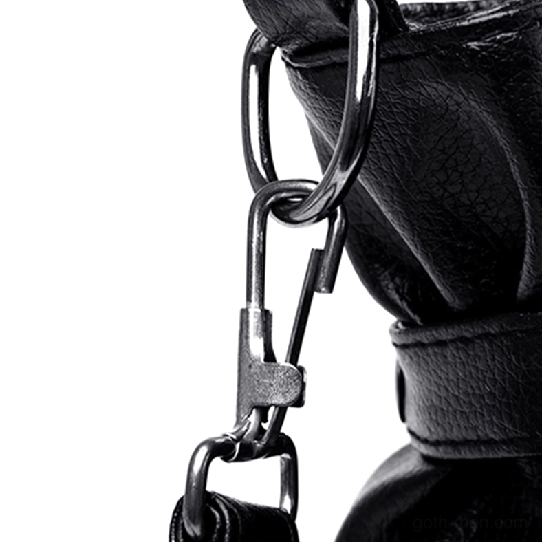 Close-up macro detail of black leather rivet decorations metal D-ring and fastener hardware on gothic handbag