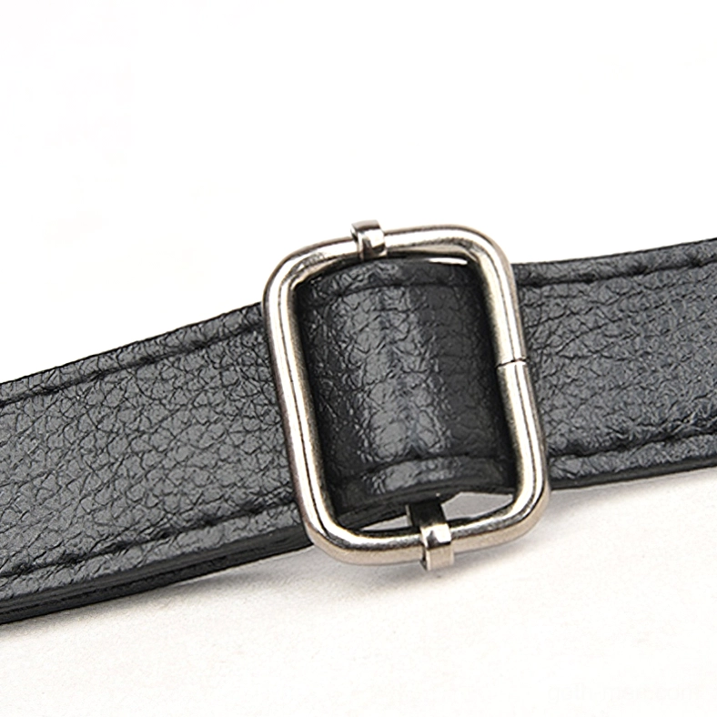 Macro shot of adjustable metal buckle and pebbled leather strap on gothic skull crossbody handbag