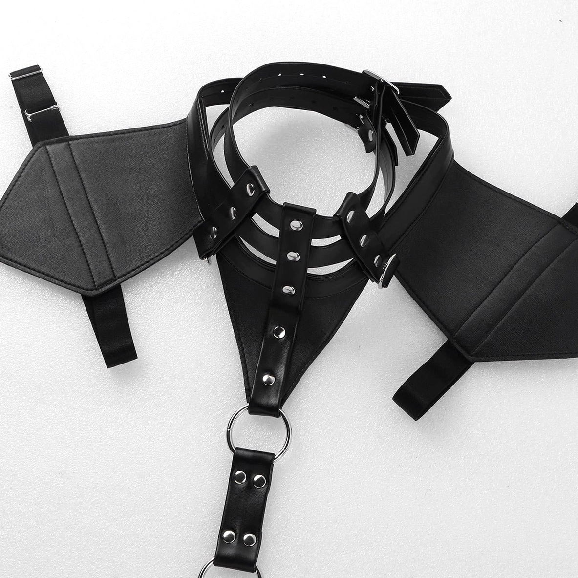 Close-up detail of gothic harness neck collar, shoulder pads, and central O-ring with riveted leather straps