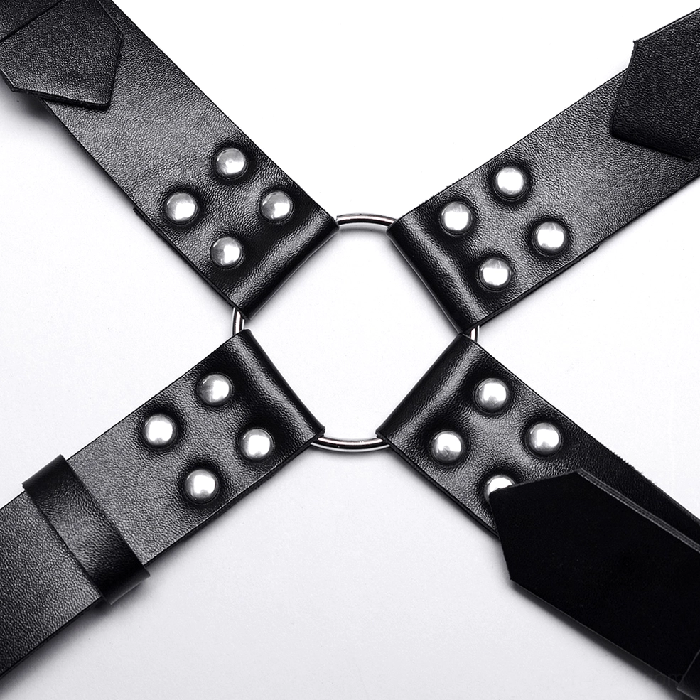 Macro close-up of metal hardware connection point on gothic harness showing round studs and central O-ring
