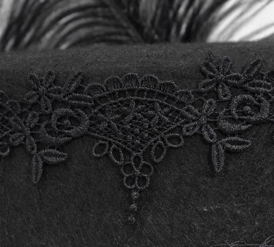 Detail of embroidered floral lace trim on black gothic top hat