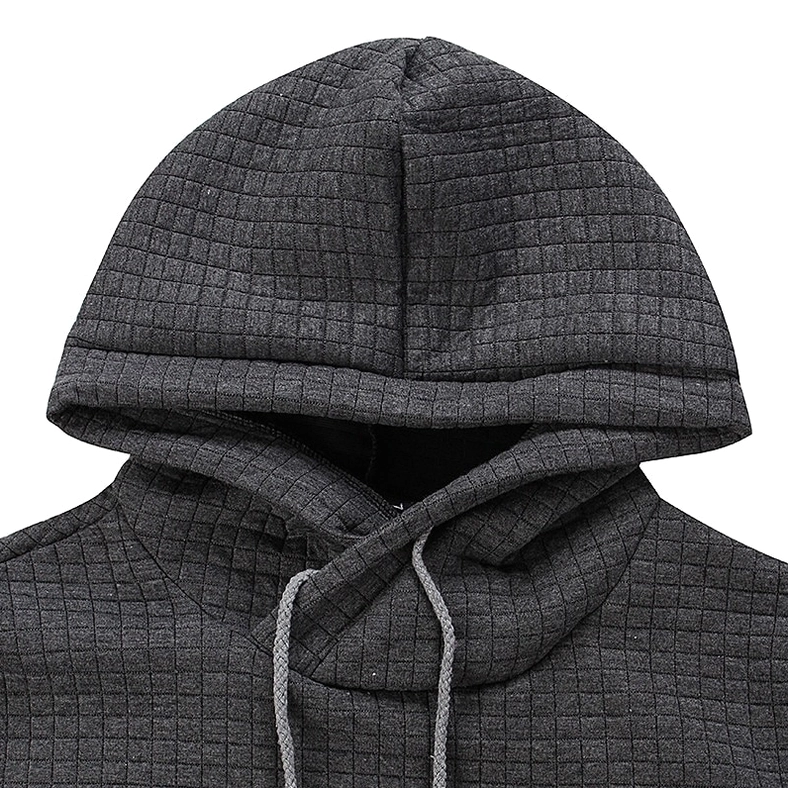 Close-up detail of dark gray quilted gothic hoodie fabric showing grid texture and drawstring hood design