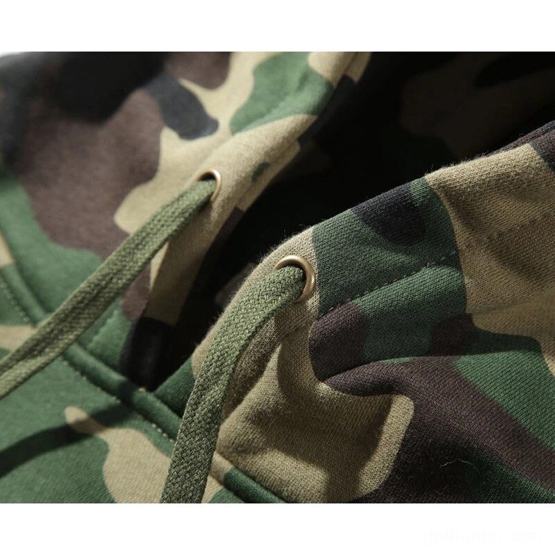 Close-up detail of metal drawstring eyelets on dark camouflage fleece hoodie hood