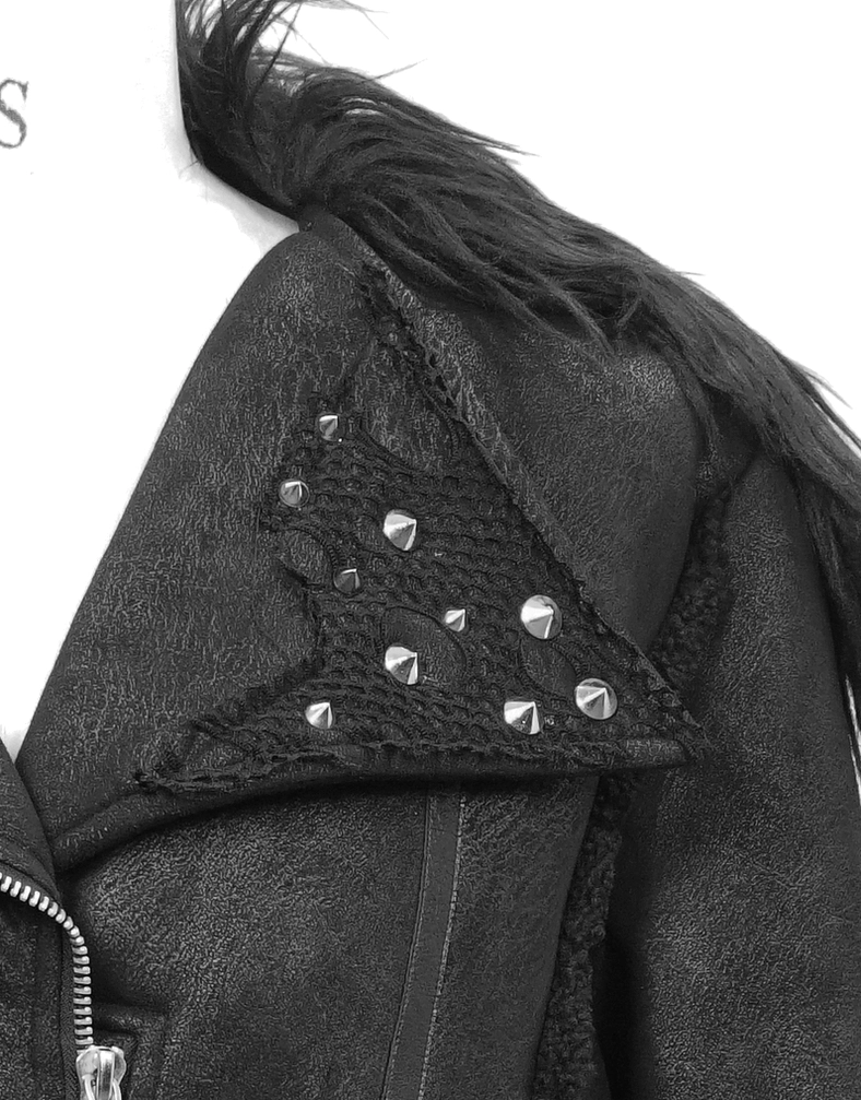 Close-up detail of gothic jacket faux fur collar with pyramid metal studs and shoulder construction