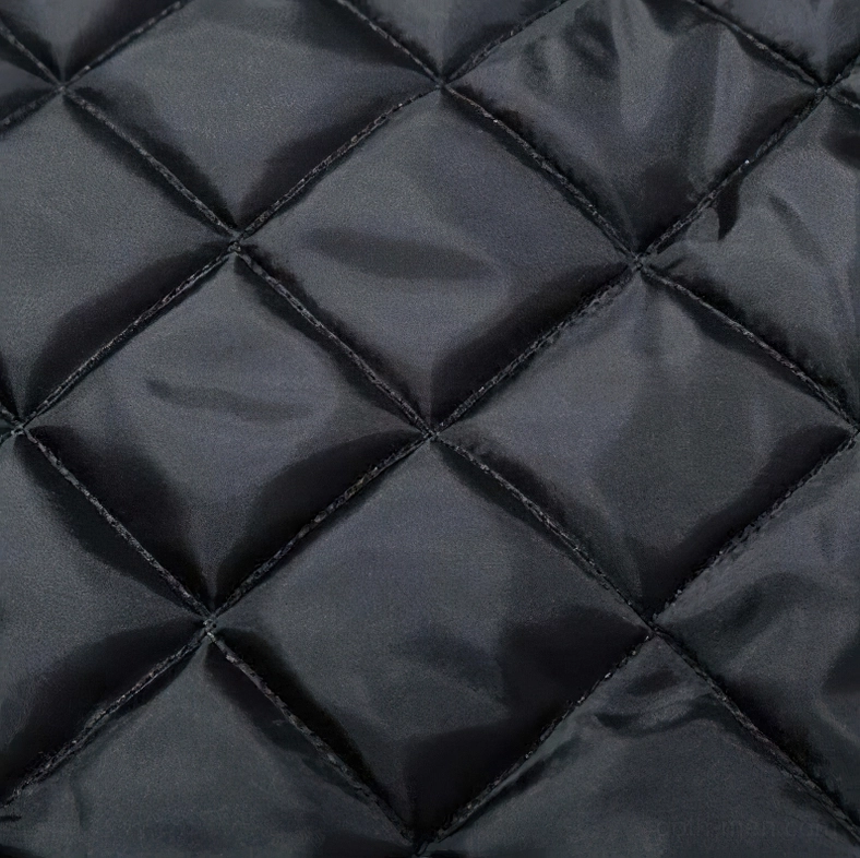 Quilted inner padding close-up - diamond stitched quilt design in black satin lining material