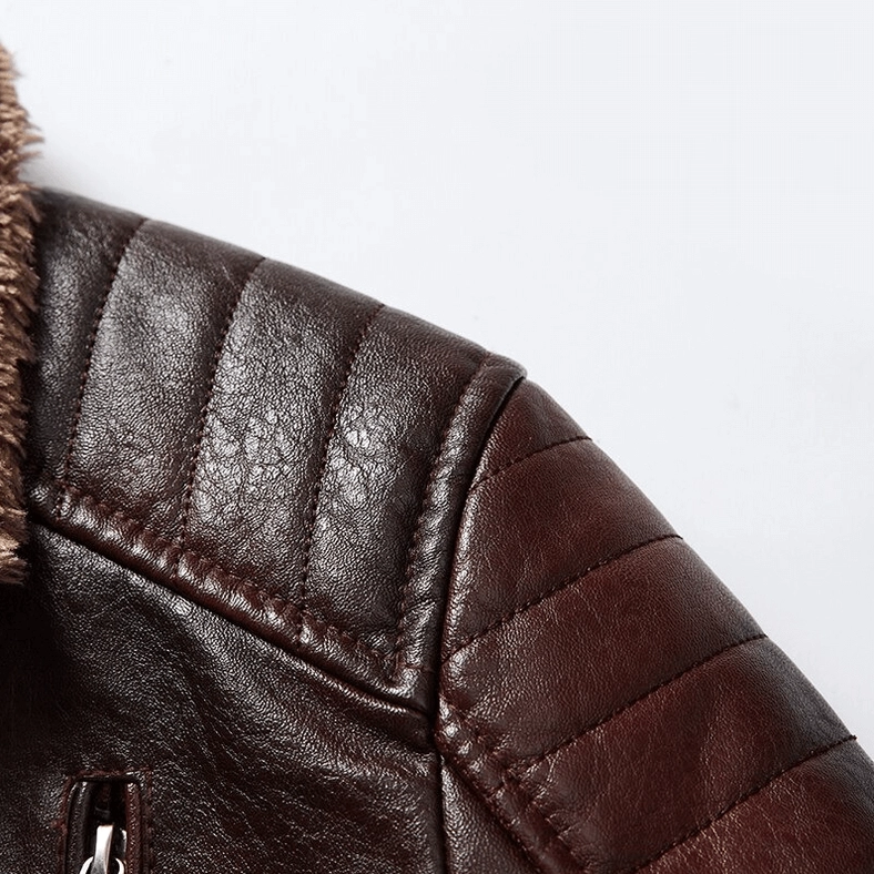 Close-up of gothic leather jacket quilted sleeve with metal zipper hardware and stitching detail