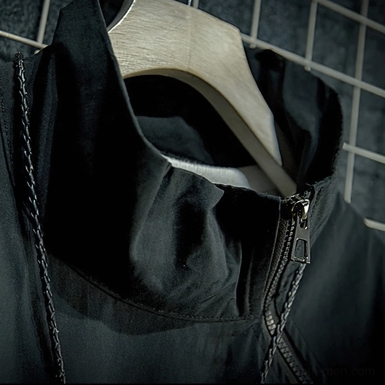 Close-up of black gothic jacket stand collar with metal zipper placket and decorative tassel necklace styling