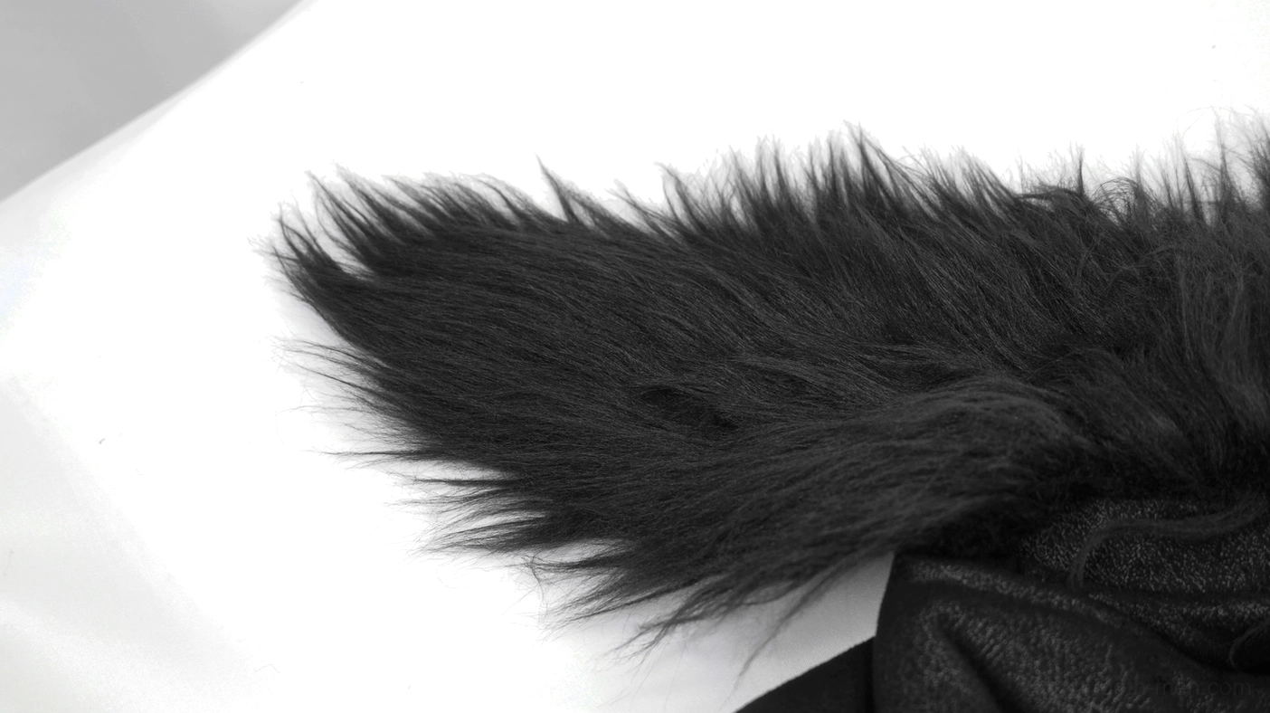 Gothic punk jacket close-up showing diagonal zipper, metal hardware, and stud placement