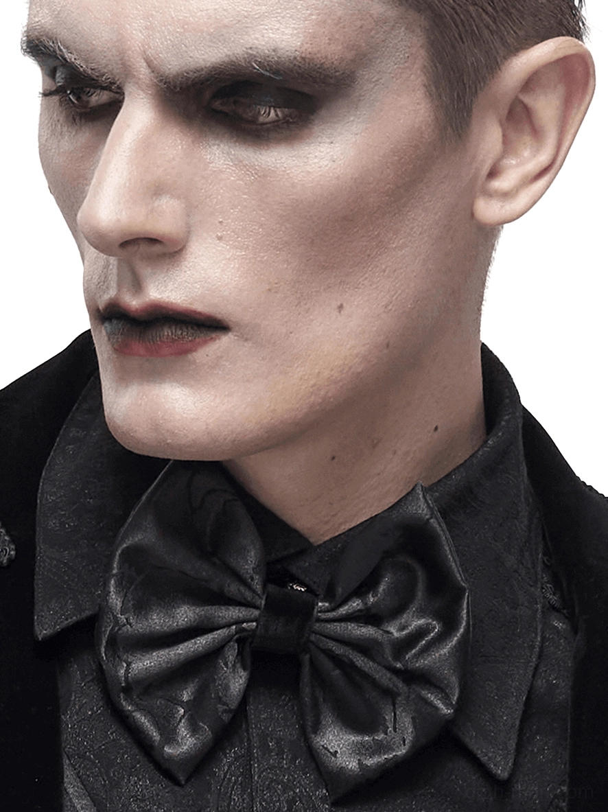 Profile view of gothic bow tie on model wearing formal black shirt, side portrait with goth makeup styling