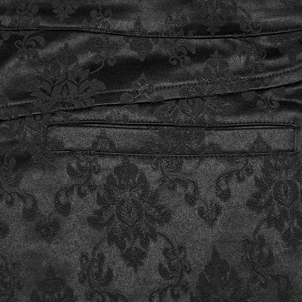 Close-up of black gothic jacquard tapered trousers pocket detail with damask pattern and stitching