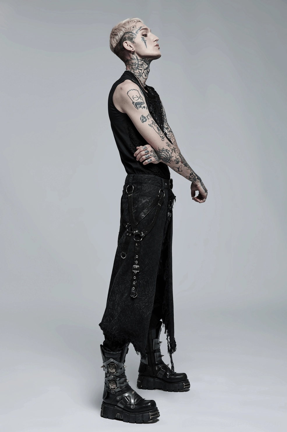 Close-up detail of black gothic kilt waistband showing adjustable eyelet holes, metal buckle, and distressed fabric surface