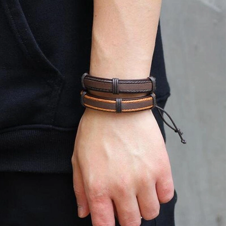 Male model wearing single brown leather gothic bracelet with layered rope chain on wrist side view