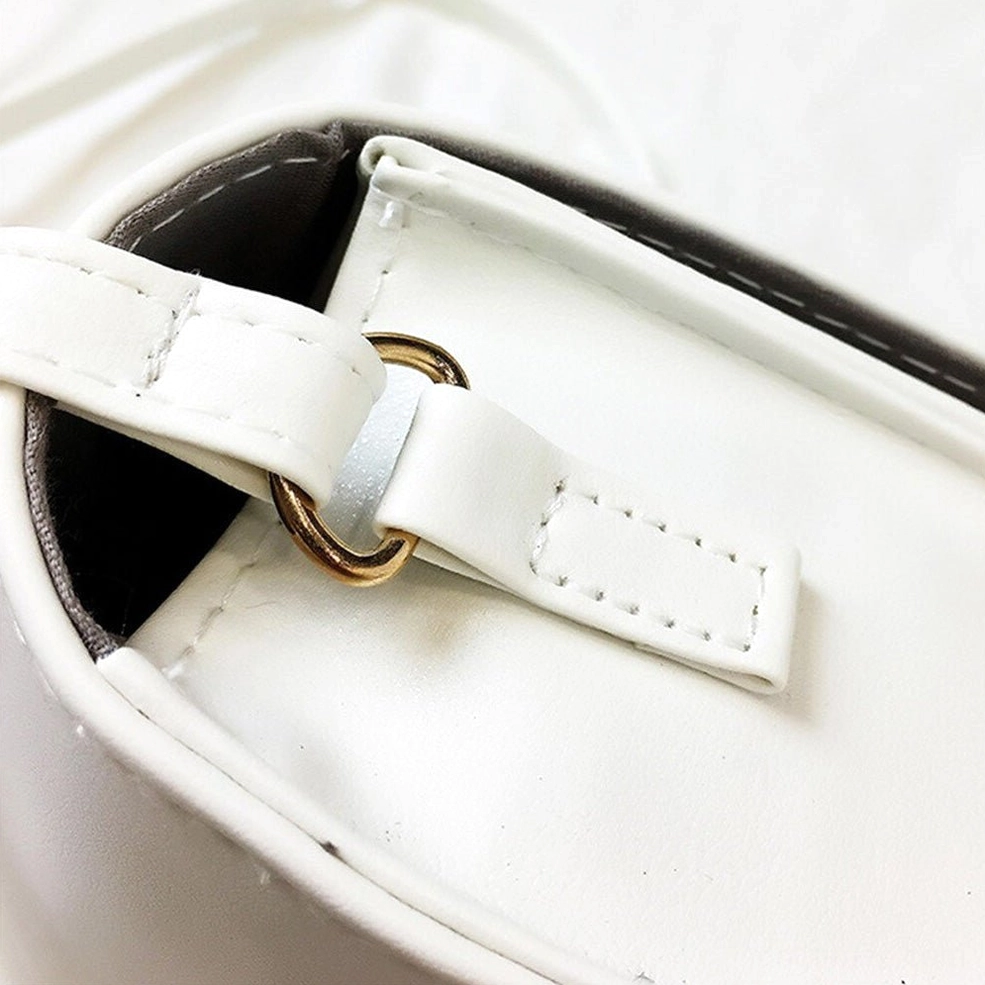 Close-up detail of gothic letter printing and text design on crossbody bag surface