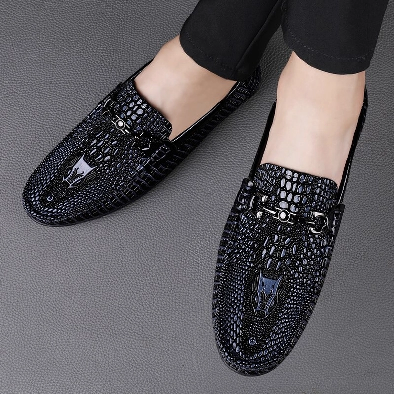Black men's gothic slip-on loafers with crocodile texture detail and metal horsbit embellishment, product showcase view