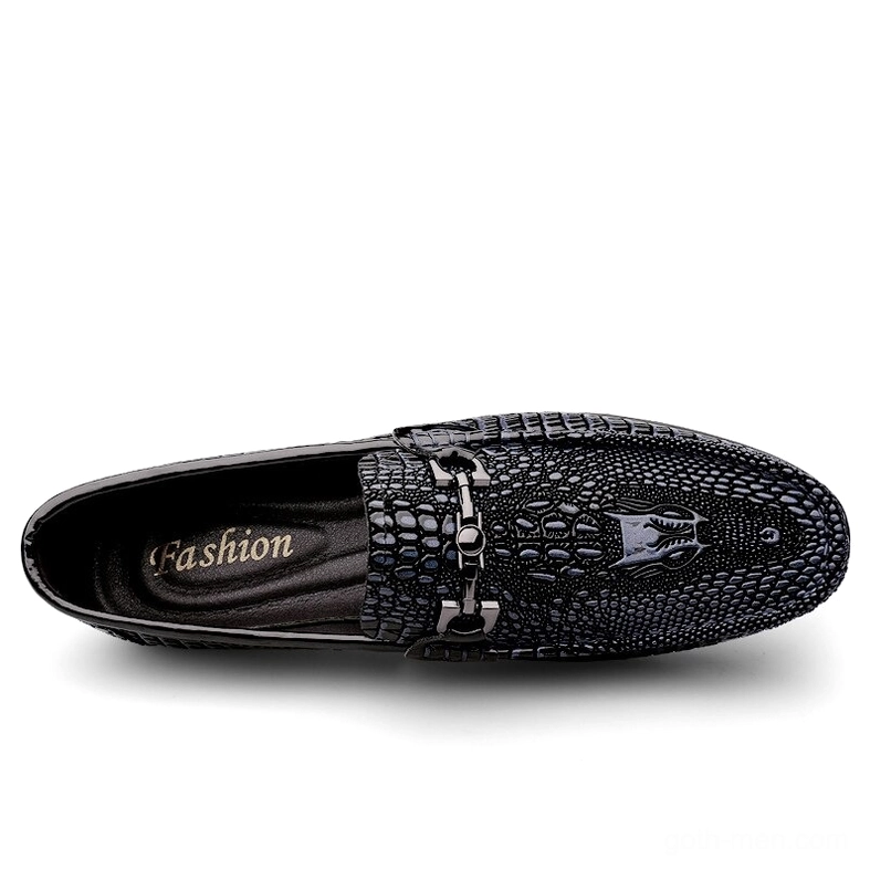 Top-down view of black gothic leather loafers showing 'Fashion' printed insole and metal horse-bit decoration detail