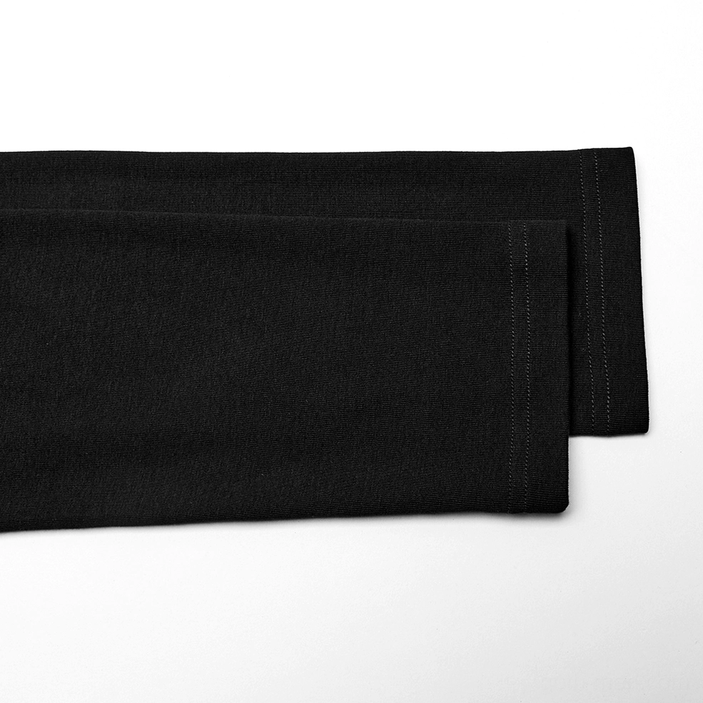 Close-up detail of black gothic mesh long sleeve top sleeve hem with stitched seam finish