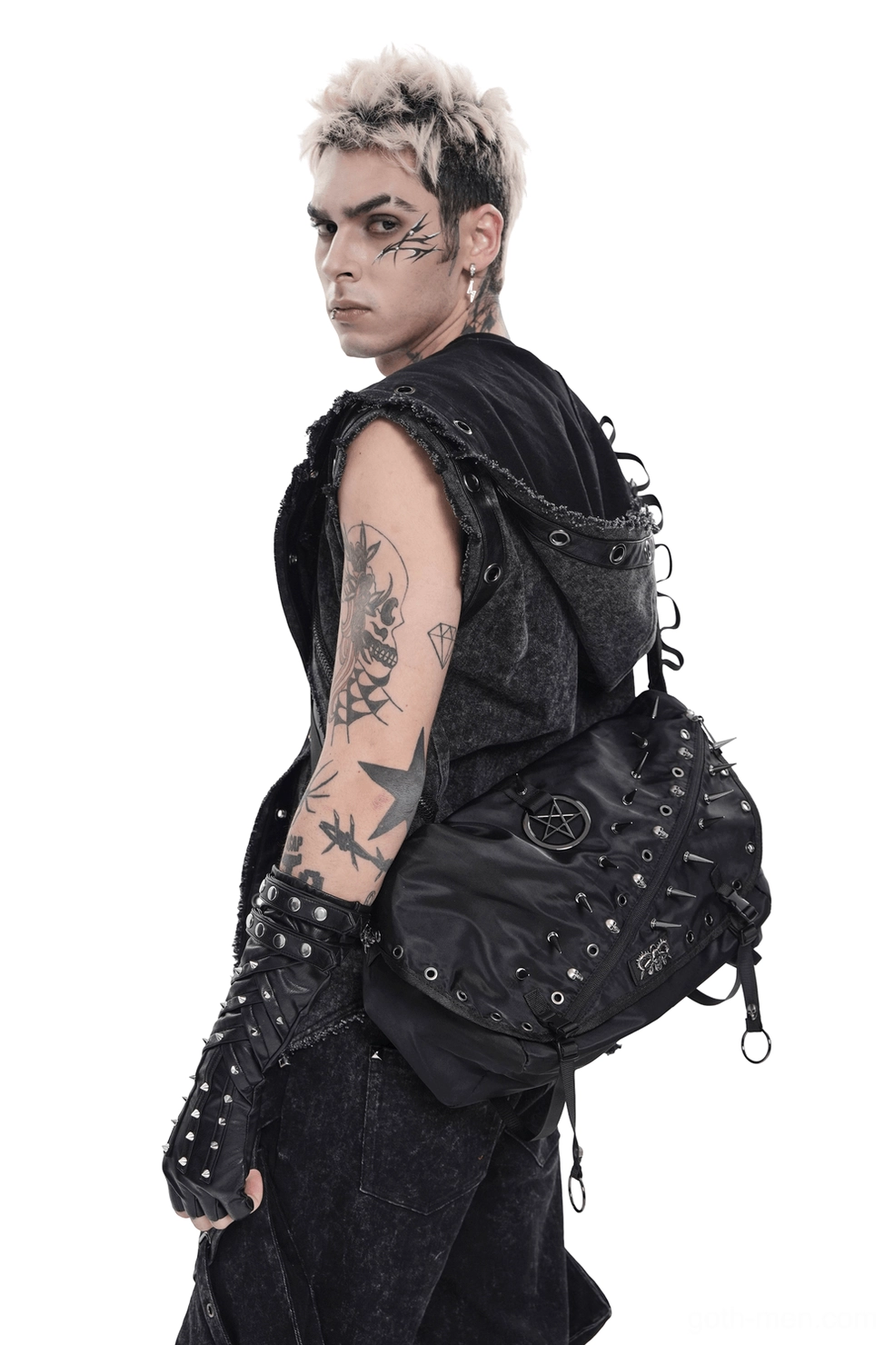 Tattooed male model wearing black pentagram studded gothic messenger bag, rear three-quarter view showcasing spike details and strap adjustment
