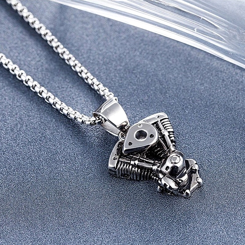 Motorcycle engine pendant low angle view, compact twin-cylinder design, gothic industrial aesthetic