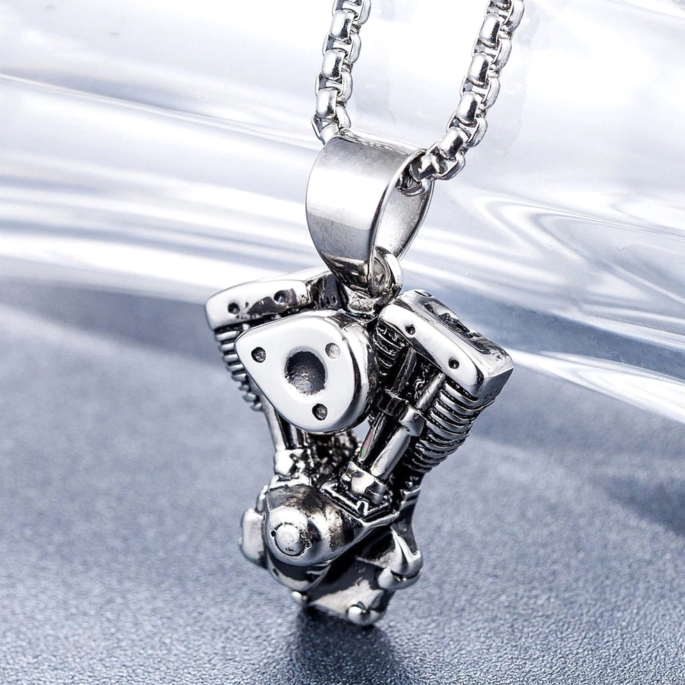 Silver stainless steel motorcycle engine pendant side view, industrial gothic design with detailed piston mechanism