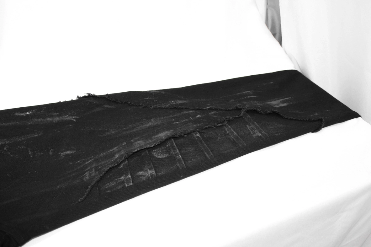Front close-up of black gothic lace-up pants showing right leg fastening and stitching detail