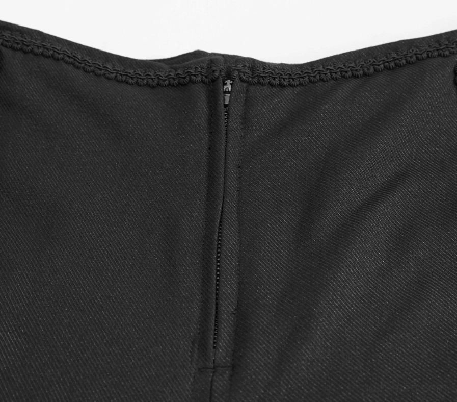 Close-up of black gothic pants front zip closure and woven fabric construction detail