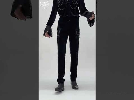 Male model full body wearing black velvet gothic slim fit trousers with chain accents and alternative styling