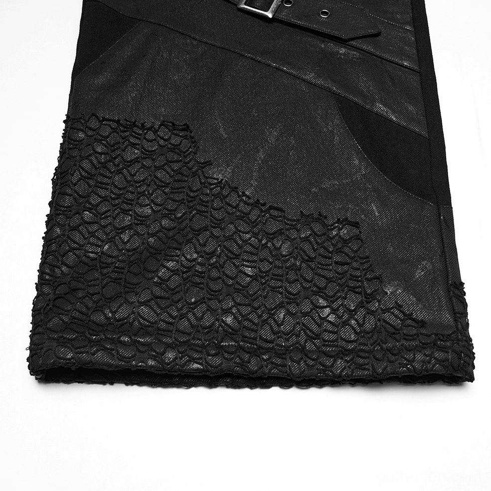 Close-up of black gothic pants hem showing scaly mesh texture and faded fabric detail