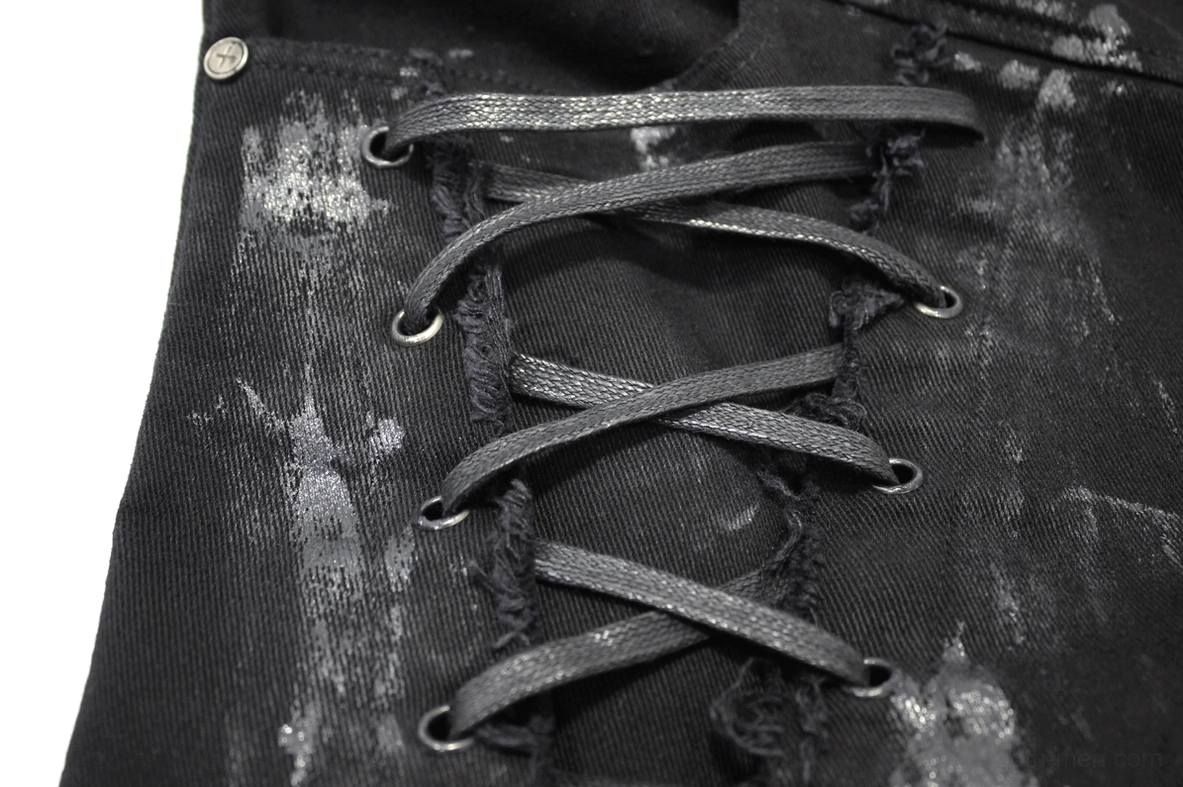 Close-up of lace-up fastening system on right leg of black gothic slim-fit pants with frayed edges