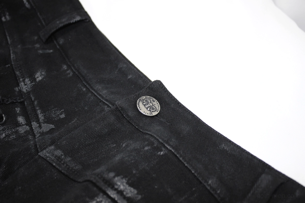 Close-up detail of black gothic trousers waistband and branded button hardware