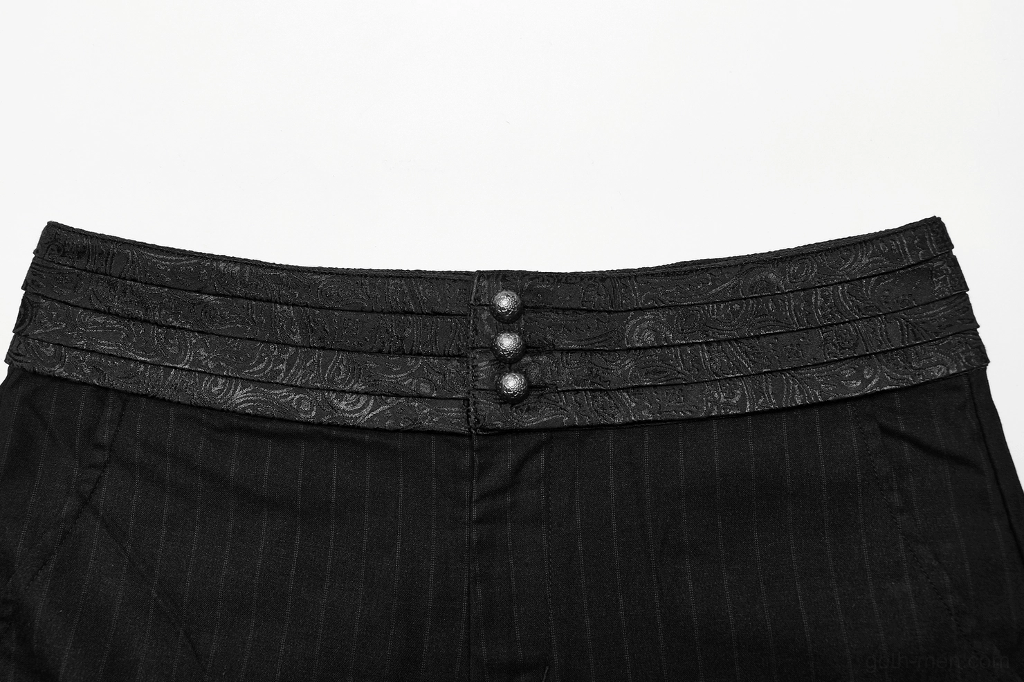 Close-up detail of gothic pants waistband with triple front buttons, embossed decorative fabric