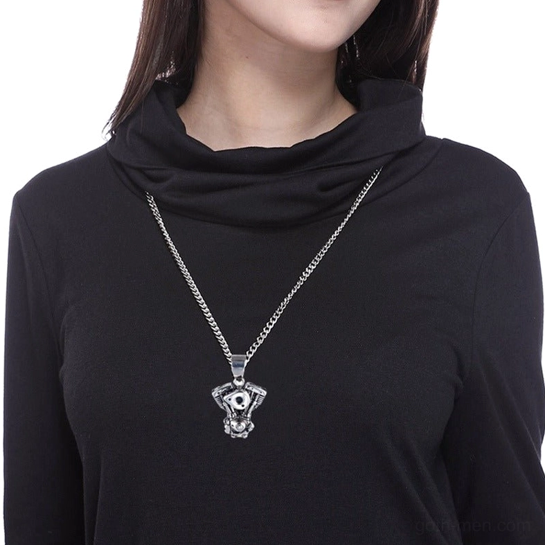 Motorcycle engine pendant worn on female model with black turtleneck, gothic necklace styling on neck