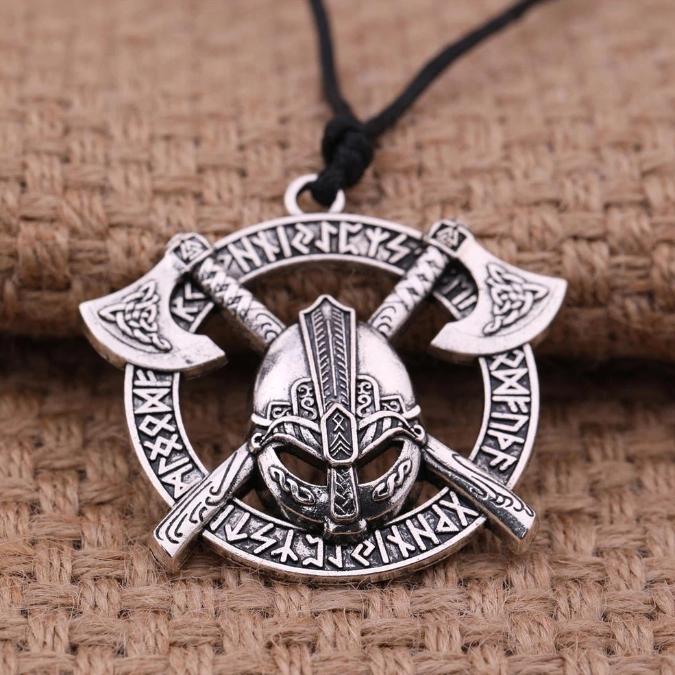 Silver-toned gothic steel pendant with helmet and axe runes on burlap fabric