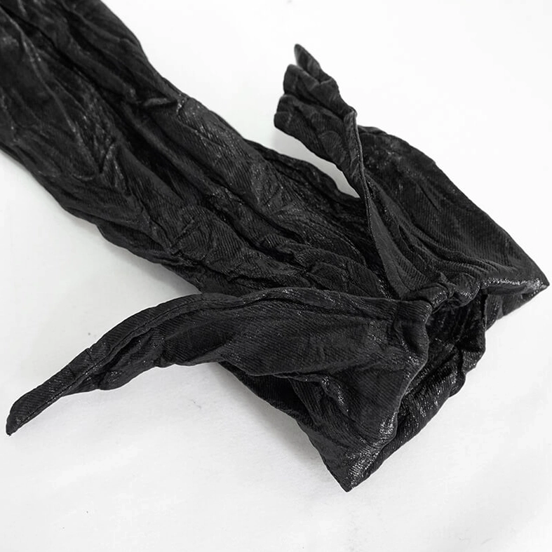 Detail of gothic black punk shirt dramatic pointed flared cuff showing crinkled synthetic leather finish