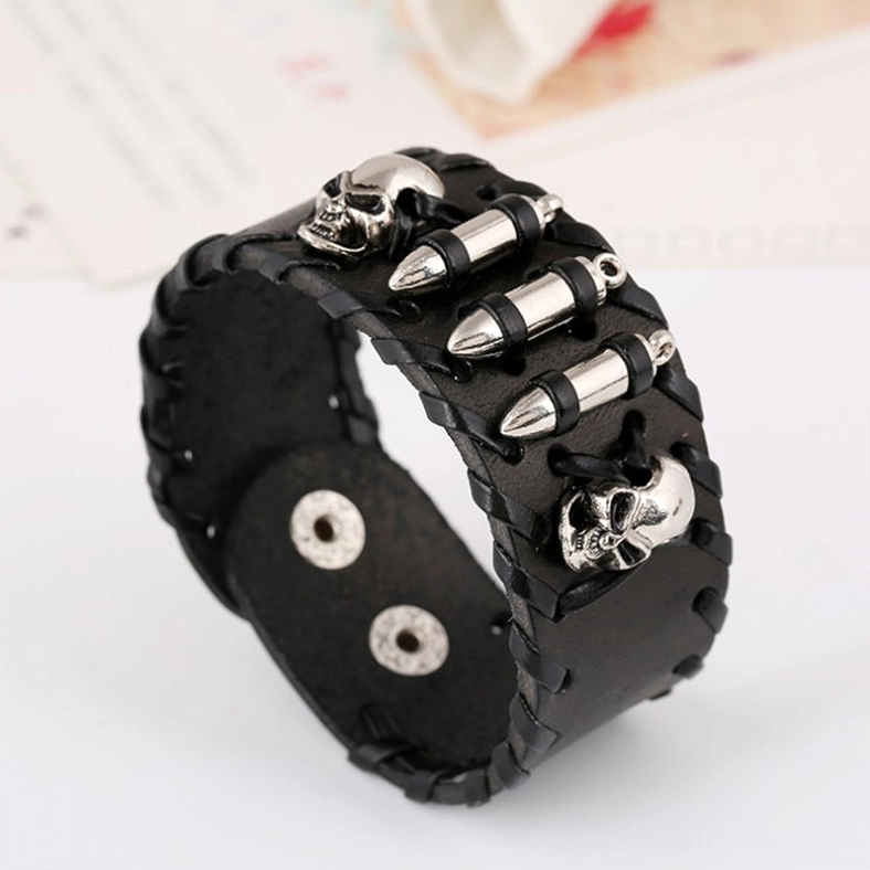 Side view of black woven leather skull bracelet with silver bullet charms and gothic metal embellishments, close-up angle shot