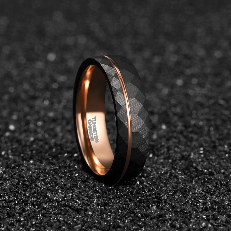 Tungsten steel gothic ring with engraved interior and rose gold accent, gravel surface photography