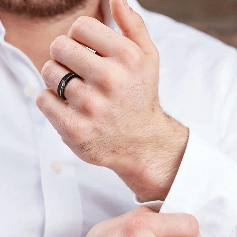 Black tungsten rhombus faceted gothic ring showing geometric facet pattern and rose gold stripe