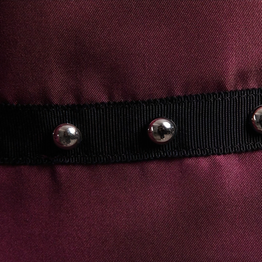 Gothic rivet shirt fabric and webbing strap close-up burgundy satin with rivets